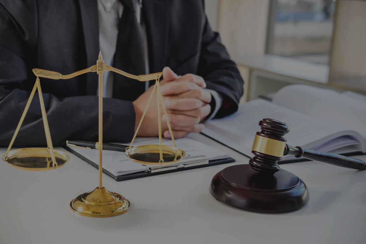 Male lawyer or judge working with Law books, gavel, report the case on table in modern office, Law and justice concept