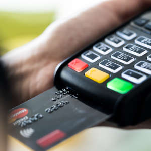 retail-store-business-owner-using-credit-card-terminal-picjumbo-com
