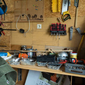 Messy table of tools in a workshop