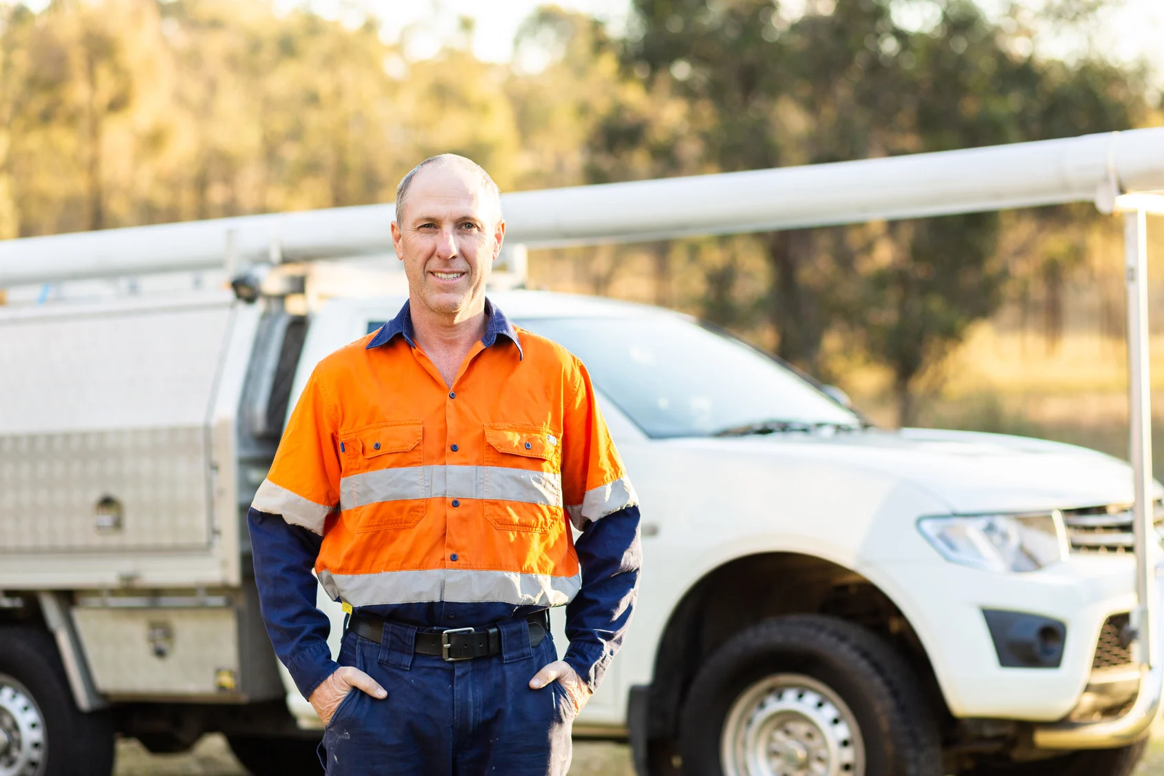 Tradesman working on job site next to commercial vehicle.